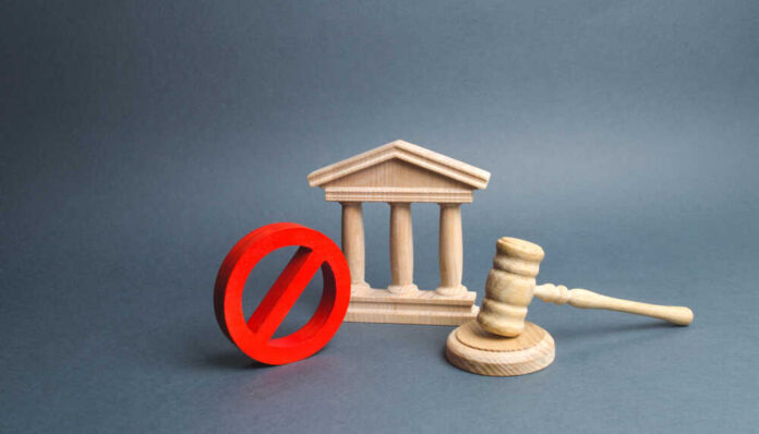 Courthouse,With,Judge's,Gavel,And,Sign,No.,Concept,Of,Censorship Wooden courthouse with red prohibition symbol and judge’s gavel
