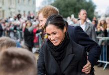 Palace Bombshell: Royals ‘Demoted’ A woman smiling and interacting with a crowd.
