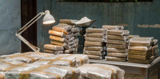 Stacks of wrapped packages in a dimly lit warehouse