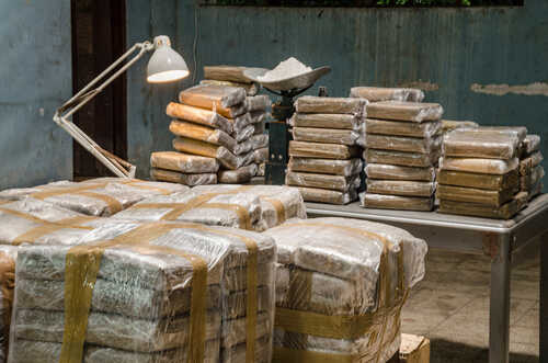 Cocaine,Warehouse,Illegal,Drug,Production Stacks of wrapped packages in a dimly lit warehouse