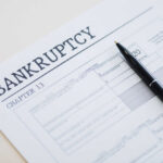 Bankruptcy Chapter 13 form with a pen resting on it