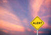 Disaster: Red State Issues Declaration Yellow alert sign against a colorful sunset sky