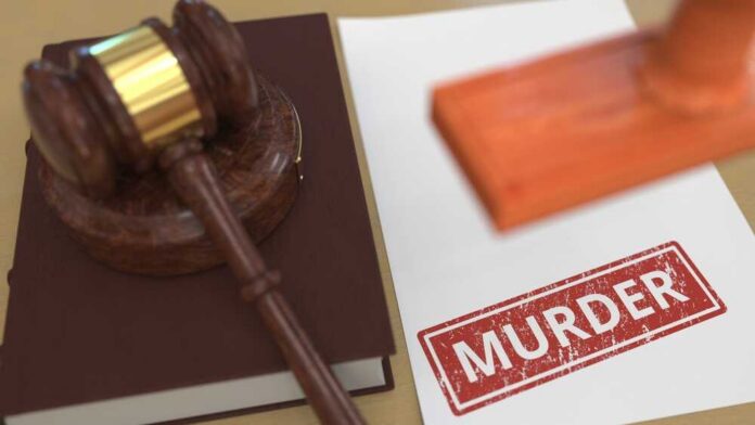 Wooden,Gavel,And,Murder,Stamp,On,The,Paper.,Court,Related Judge's gavel on a law book beside a stamped document
