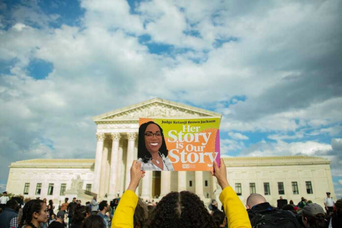 shutterstock_2144065295 People holding sign for Judge Ketanji Brown Jackson.