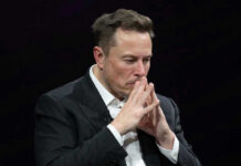 Shock Win: Musk’s Two Words Ignite Europe Elon Musk in a suit deep in thought, black background.