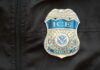 FBI vs. ICE: Explosive Lie Allegations Close-up of an ICE officer badge on a black jacket