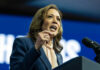 Woman speaking at a podium with microphone.