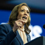 Woman speaking at a podium with microphone.