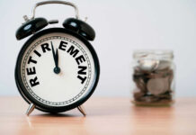 Alarm clock showing retirement and jar of coins