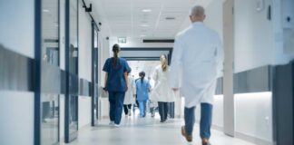 Medical staff walking through a hospital corridor