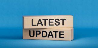 Wooden blocks with the words latest update on blue background