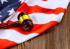 Judge’s Chilling Rebuke Gets Courtroom Applause A gavel resting on an American flag