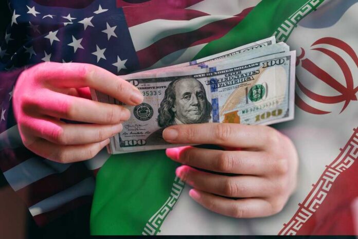 Two,Hands,Hold,Several,One,Hundred,Dollar,Bills,In,Front Hands holding a $100 bill with American and Iranian flags in the background