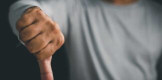 A hand showing a thumbs down gesture