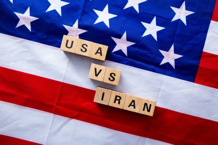 Usa,And,Iran,Confronting,Each,Other,With,Wooden,Blocks,On Wood letter blocks on an American flag