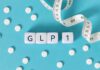 GLP-1 Bombshell From Lib Gov Prescription pad with various colorful pills and a stethoscope