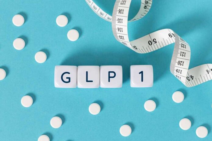 Glp,1,Word,On,Blocks,Surrounded,By,Medicine,Pills,And Prescription pad with various colorful pills and a stethoscope