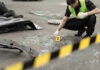 Doctor’s Corpse Rekindles Tylenol Murders Mystery Police investigating crime scene with evidence marker and body bag.