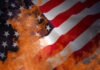 Stunning Defeated: Governor Dumped In Landslide American flag partially set on fire with orange flames.