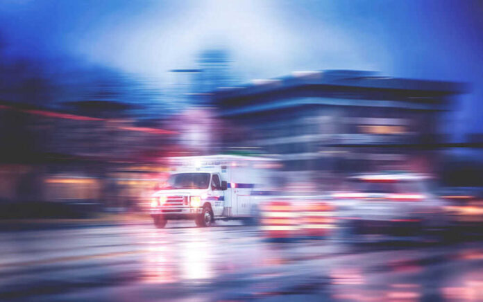 shutterstock_532768414 Ambulance speeding through city street at night