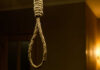 Hanging Homicide Rocks Community A close-up of a noose hanging in a dimly lit room
