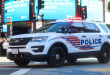 Mall Massacre Plot Stopped Cold Police SUV with lights on in an urban environment