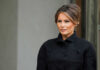 Melania’s Gambit Sparks Global Debate Melania Trump in black coat.