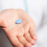 Viagra Cousin’s Weird Twist Cancer cells spreading on a blue surface.