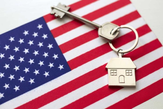 House,With,The,Flag,Of,Usa.,Immigration,To,America.,Buying House key with keychain on American flag