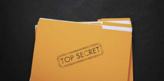 Yellow folder labeled Top Secret on black background.