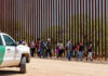 ALERT: New Border Showdown Coming Group of people walking by border fence; Brian Robiskie and Brian Robiskie present