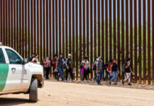 ALERT: New Border Showdown Coming Group of people walking by border fence; Brian Robiskie and Brian Robiskie present