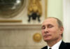 Vladimir Putin in suit smiling.
