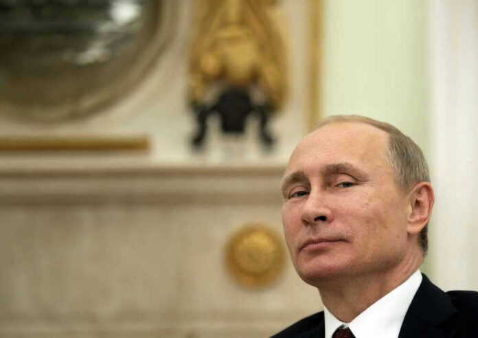 shutterstock_2351882315 Vladimir Putin in suit smiling.