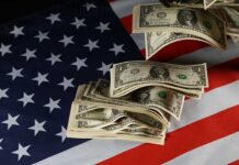 Billion-Dollar Promise Stuns Wall Street Dollar bills arranged on an American flag