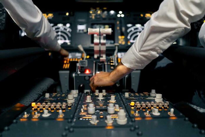 Close-up,Of,The,Cockpit,Of,A,Passenger,Plane,With,Many Pilots operate controls in an airplane cockpit