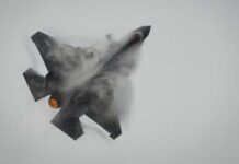 Trump Rally Airspace Breached Fighter jet performing an aerial maneuver with smoke trailing behind