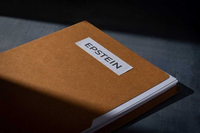A,File,Folder,Labeled,Epstein,On,A,Dark,Surface.,Investigations, A brown folder with a label reading 'EPSTEIN'