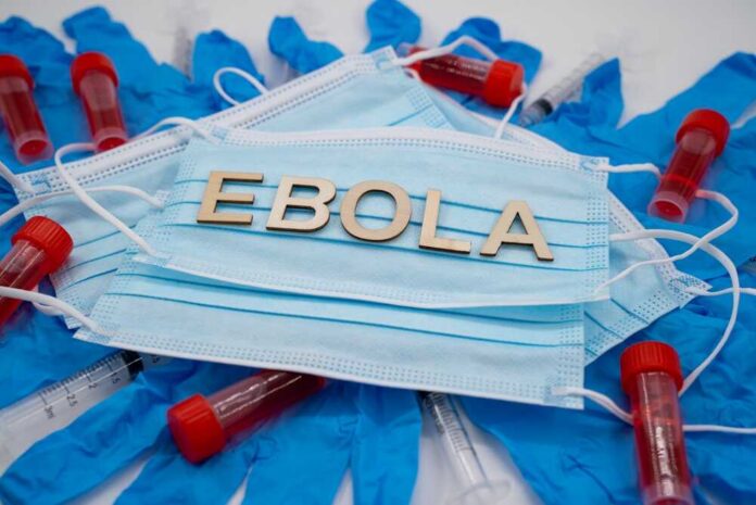 Ebola,Medical,Concept,With,Masks,Gloves,And,Laboratory,Samples. Face masks with lab vials and gloves arranged around them