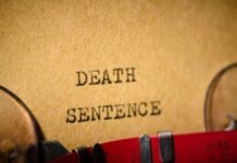 Chaotic Execution – Mic Cuts, Snoring Continues Typewriter typing the words death sentence on paper