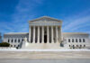 Sweeping Injunction Triggers SCOTUS Clash U.S. Supreme Court building under clear blue sky.