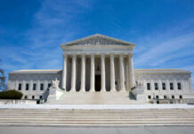 Sweeping Injunction Triggers SCOTUS Clash U.S. Supreme Court building under clear blue sky.