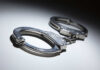 Close-up of metallic handcuffs on a light surface